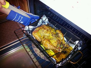 The roasted chicken coming out of the oven.