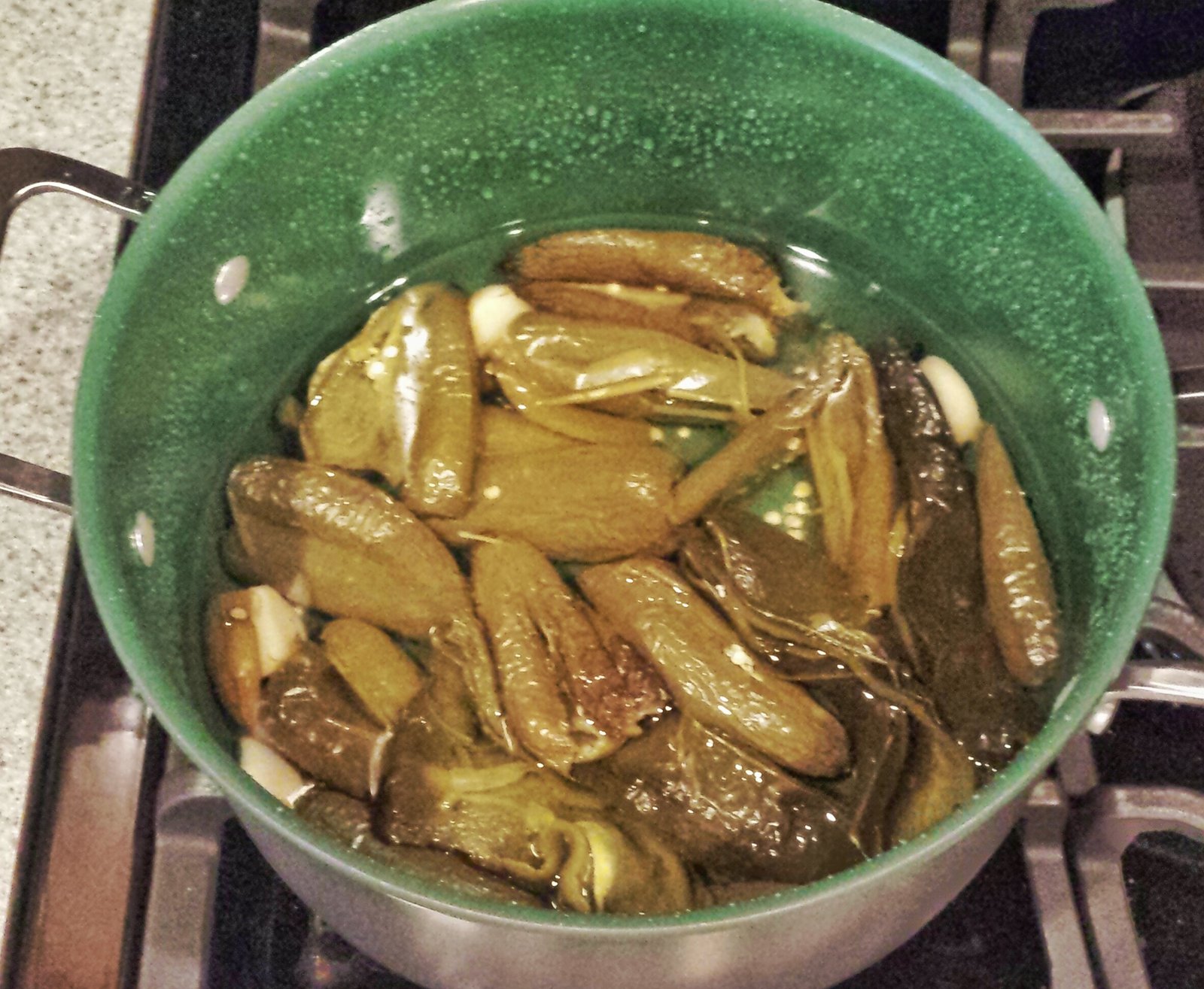 Peppers and garlic covered in water.