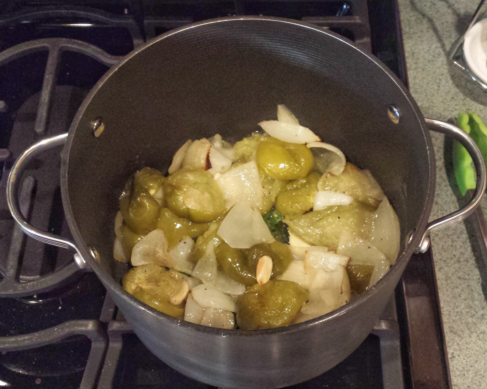 Tomatillos, onions, garlic and cilantro in our dutch oven.