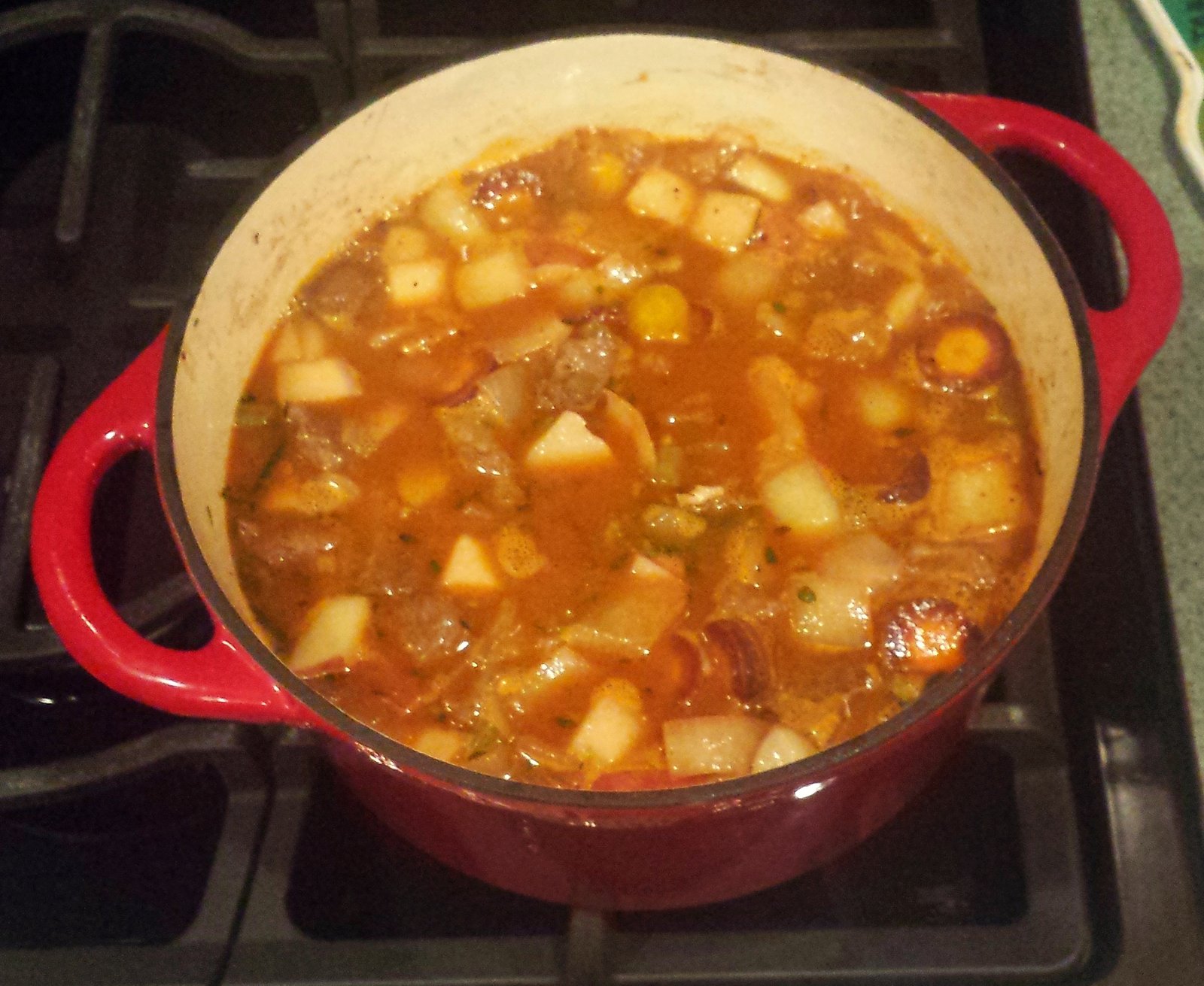 The pot roast stew simmering in the dutch oven.