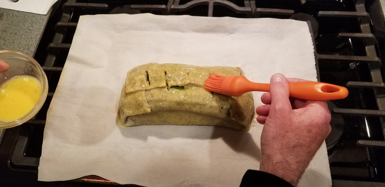Egg wash on the salmon en croute before we put in the oven.