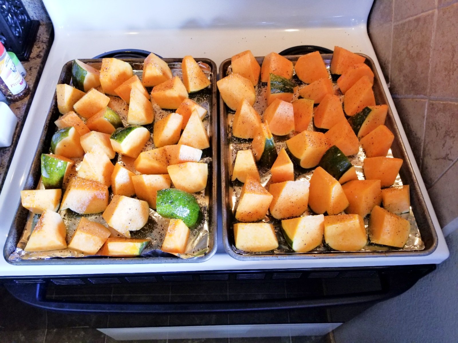 Here are the pieces of pumpkin that have a light coating of olive oil, salt, and pepper, and are ready to be roasted.