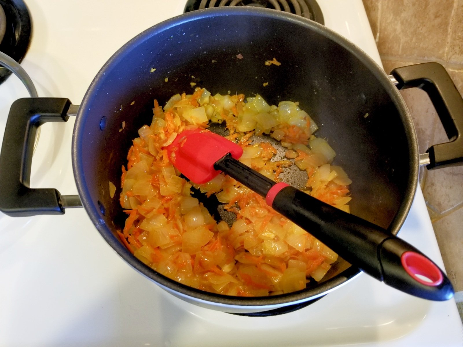 Here are the onion, carrots, ginger and garlic cooking.