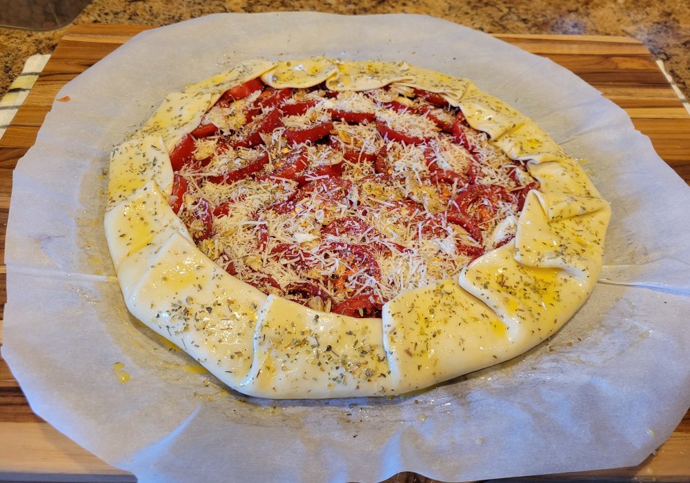 Fold the dough over the tomatoes to create the border.