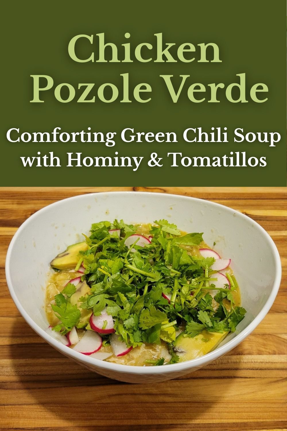 Bowl of Chicken Pozole Verde topped with fresh cilantro, avocado, and radish slices on a wooden cutting board, with green title banner reading “Chicken Pozole Verde – Comforting Green Chili Soup with Hominy & Tomatillos.”