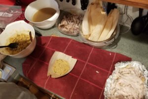 Masa and stuffing mixture spread onto a softened corn husk.